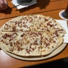 Foto zu Cafe 59: Flammkuchen klassisch mit Speck und Zwiebeln 2026 11,90 €