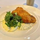 Foto zu Restaurant & Deli der Bullerei by Tim Mälzer: Seelachsfilet in knusprigem Backteig mit hausgemachter Remoulade, Kräutersalat und Kartoffelpüree.