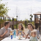 Foto zu Á la carte Restaurant - im Van der Valk Resort Linstow: Terrasse mit Spielplatz